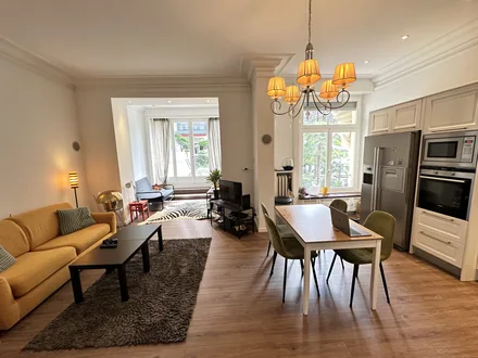 Séjour et salle à manger ouverts, cuisine en arrière-plan